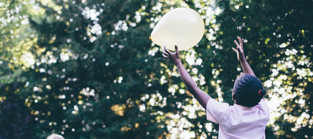 Girl letting go of a balloon